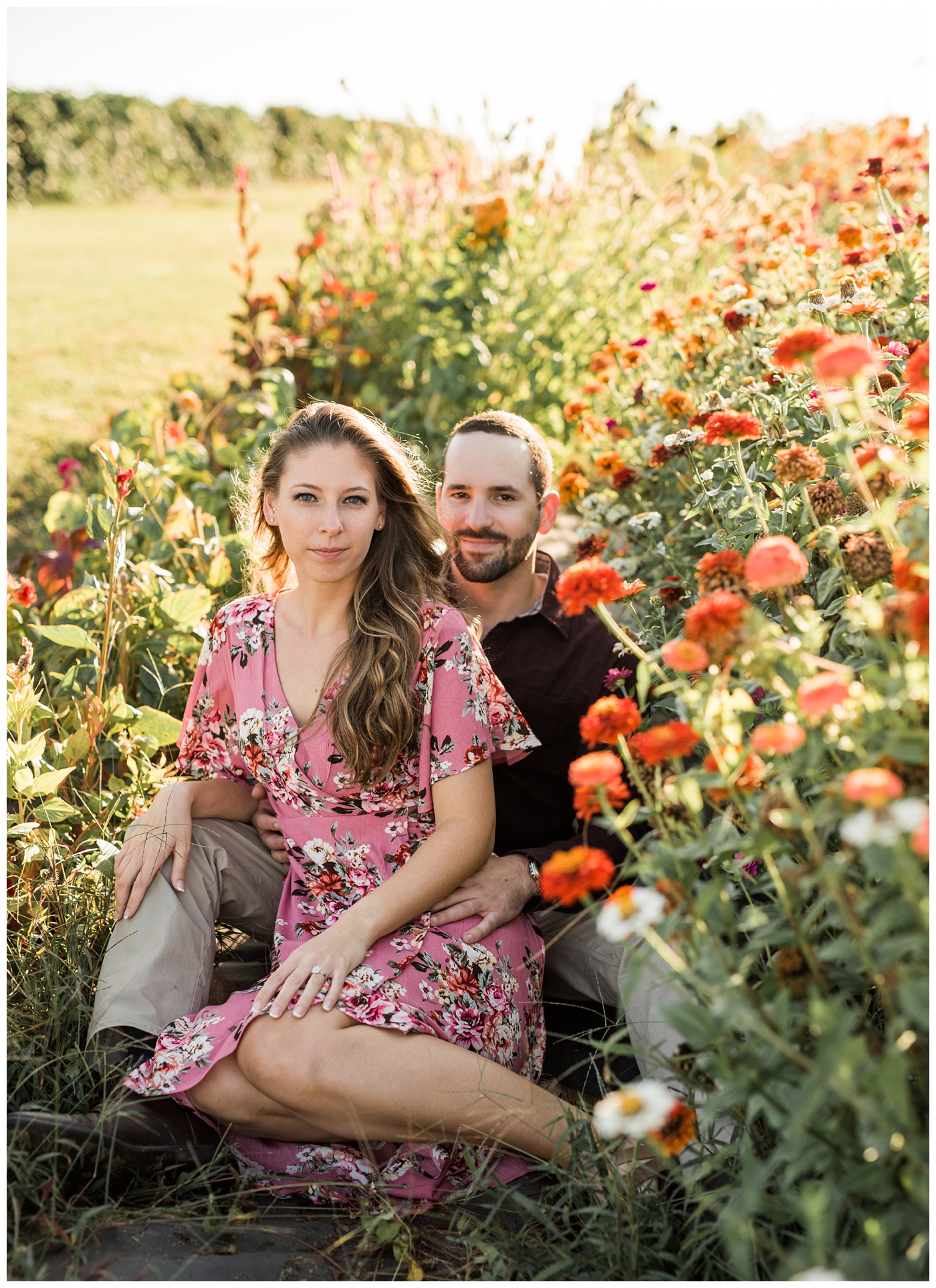 Couple laying in a wild flower field 