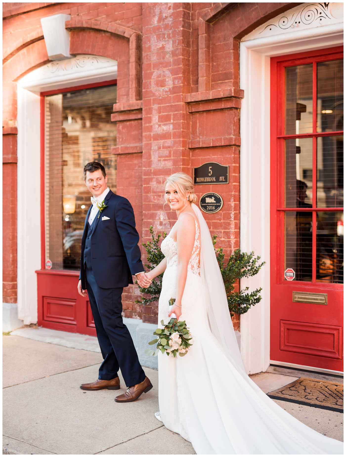 Bride and groom walking downtown in Staunton Virginia at the American Hotel