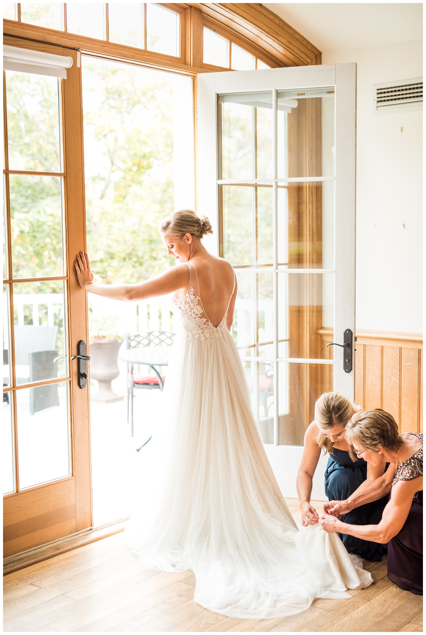 Bride getting in her dress at Castle Hill Cidery