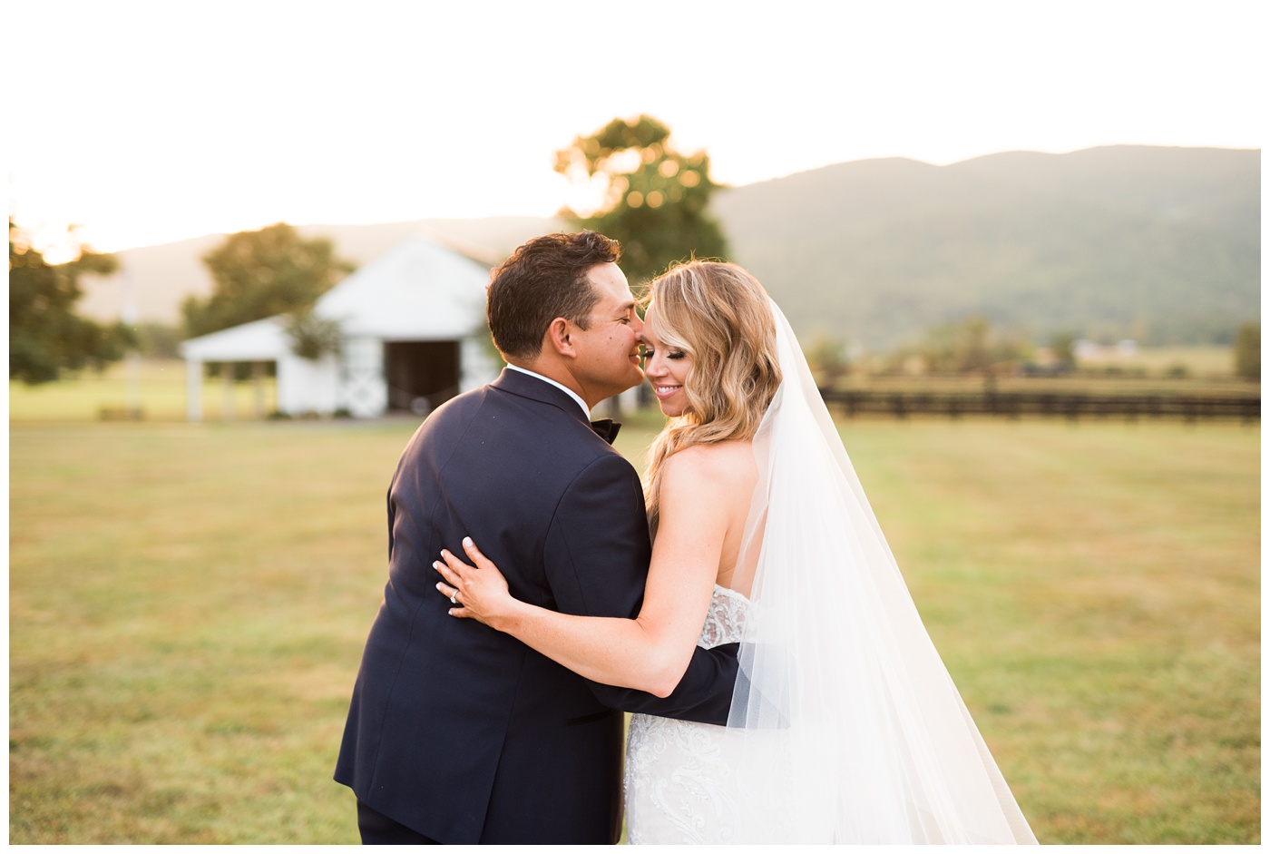 Bride and Groom cuddling at sunset on their wedding day at King Family Vineyard in Charlottesville VA 