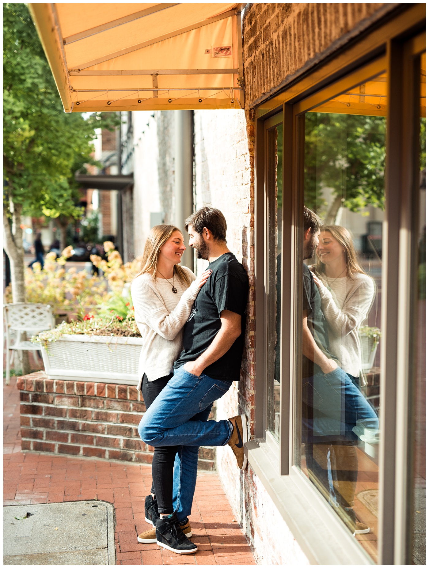 Engaged couple walking around the downtown mall in Charlottesville VA