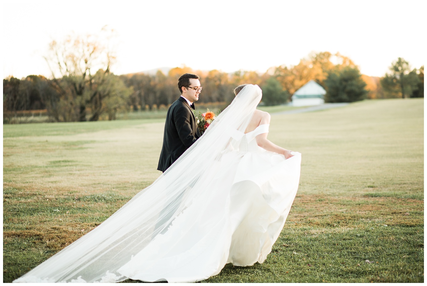 Bride and Groom with colorful Fall leaves and Virginia mountain backdrop at King Family Vineyard