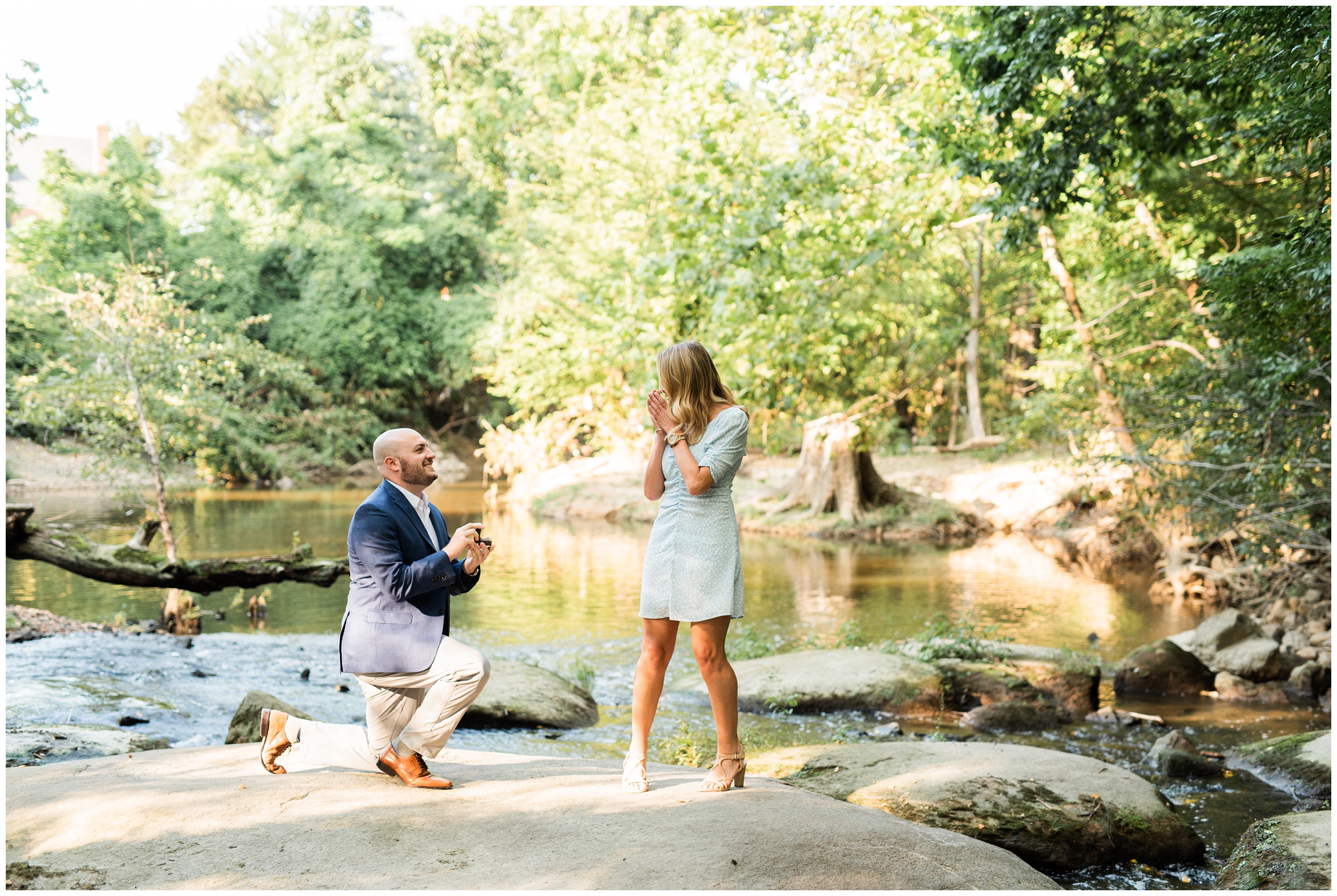 Guy proposing in front of river in Richmond Virginia