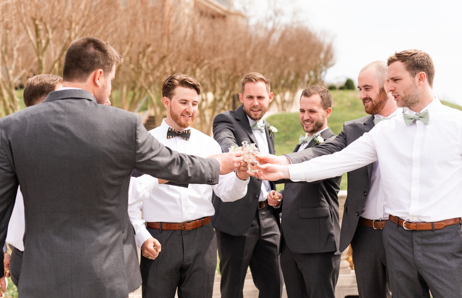 Groom toasts with his groomsmen at the Estate at River Run