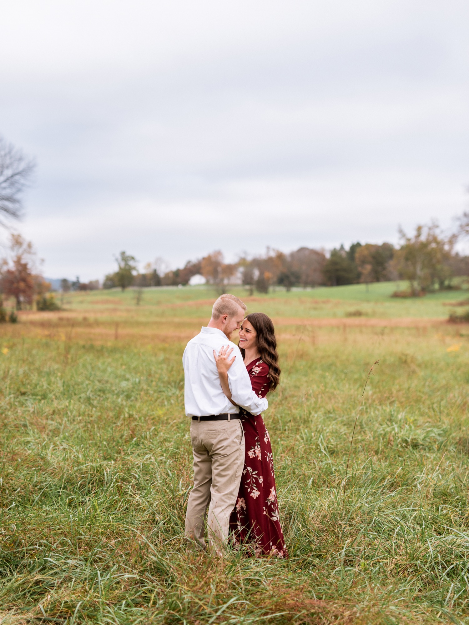 couple embrace during engagement shoot in Charlottesville