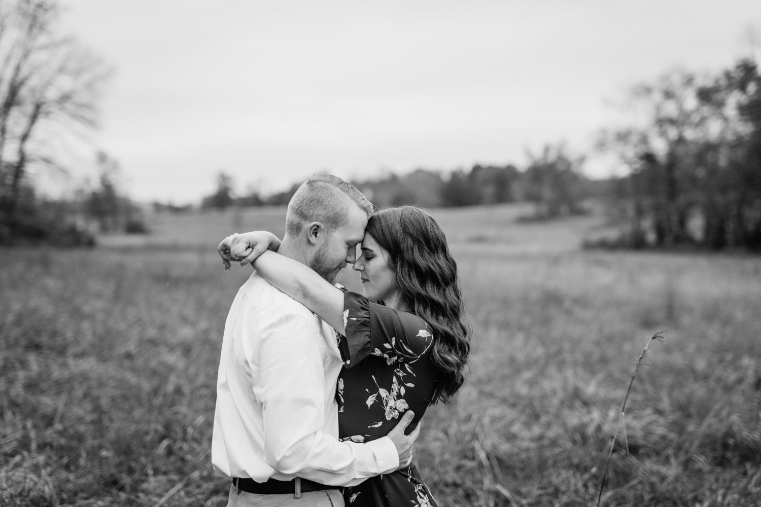 couple embrace during engagement shoot in Charlottesville