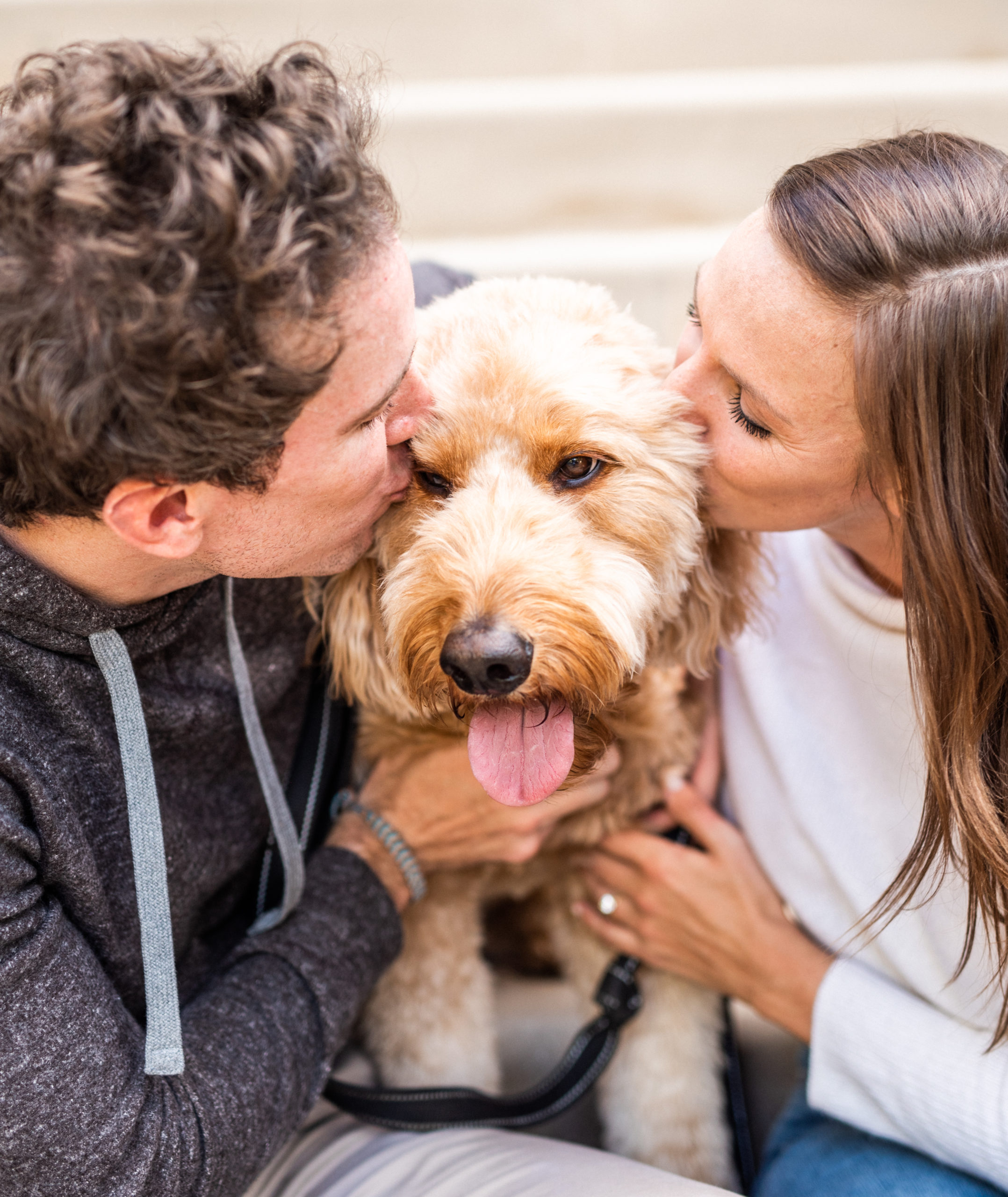 couple share a kiss with their dog in Georgetown