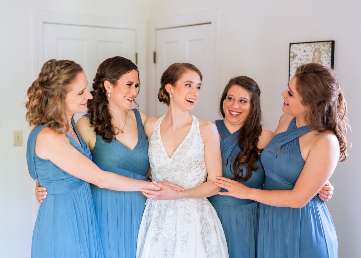 bridesmaids and bride embrace before ceremony