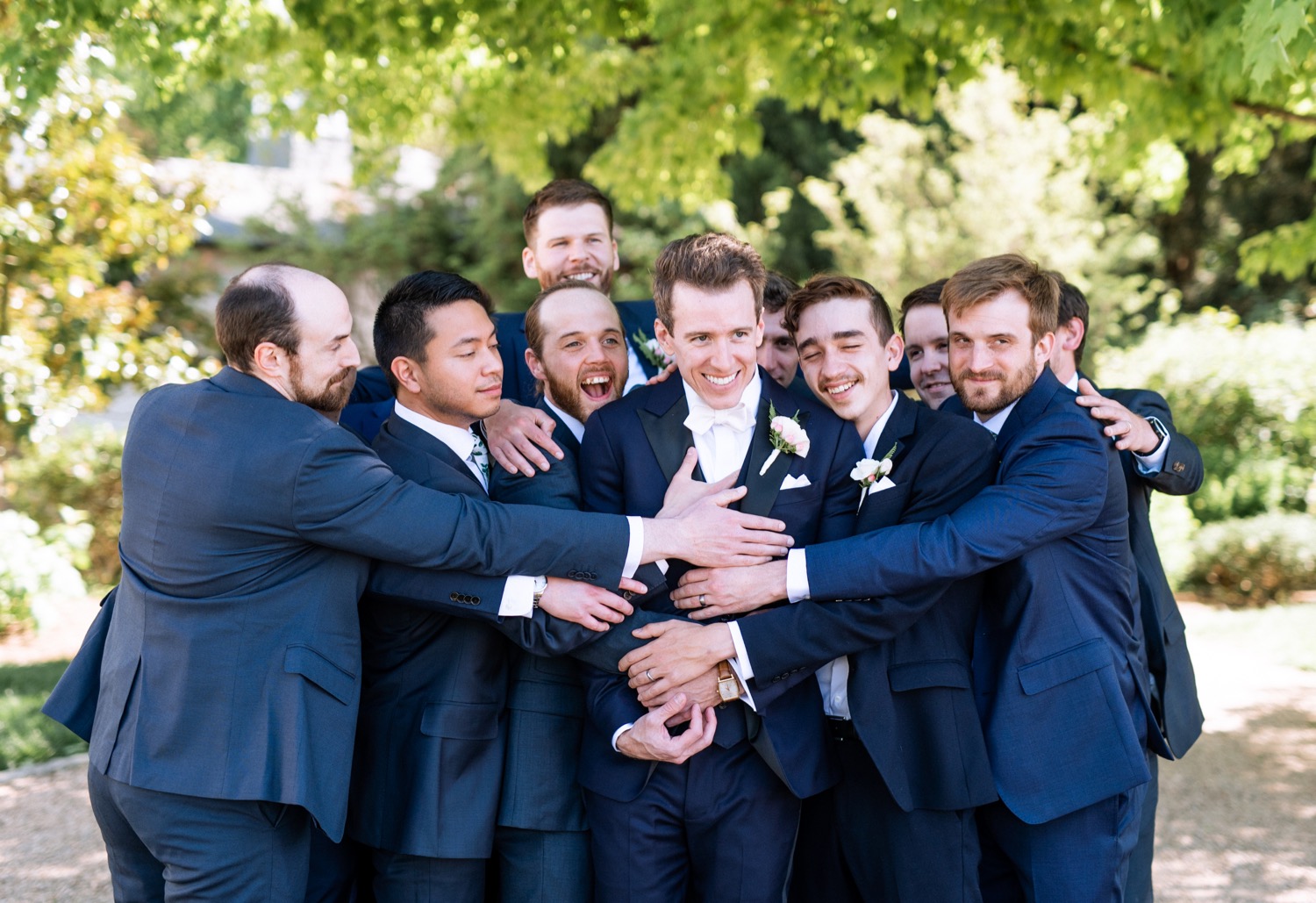 groomsmen hug groom at Keswick Vineyard wedding