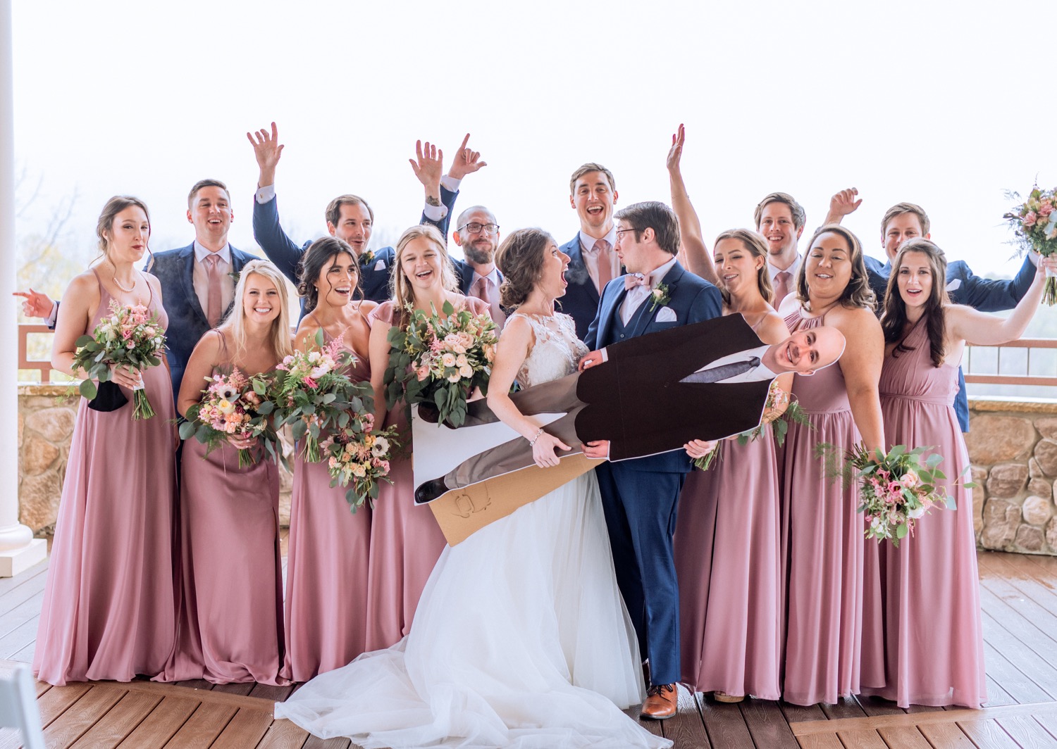 Bride and groom pose with bridal party and cardboard best man at Irvine Estate