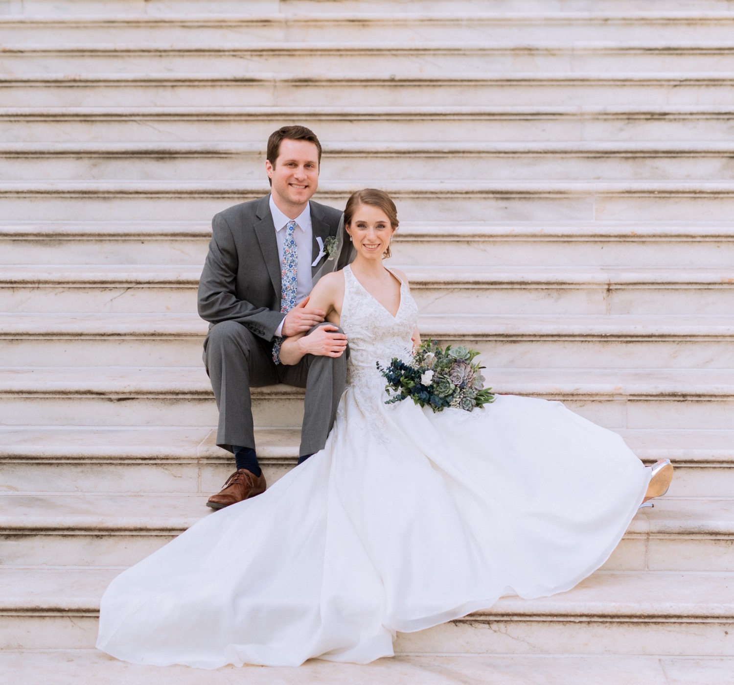 bride and groom sitting together on UVA steps