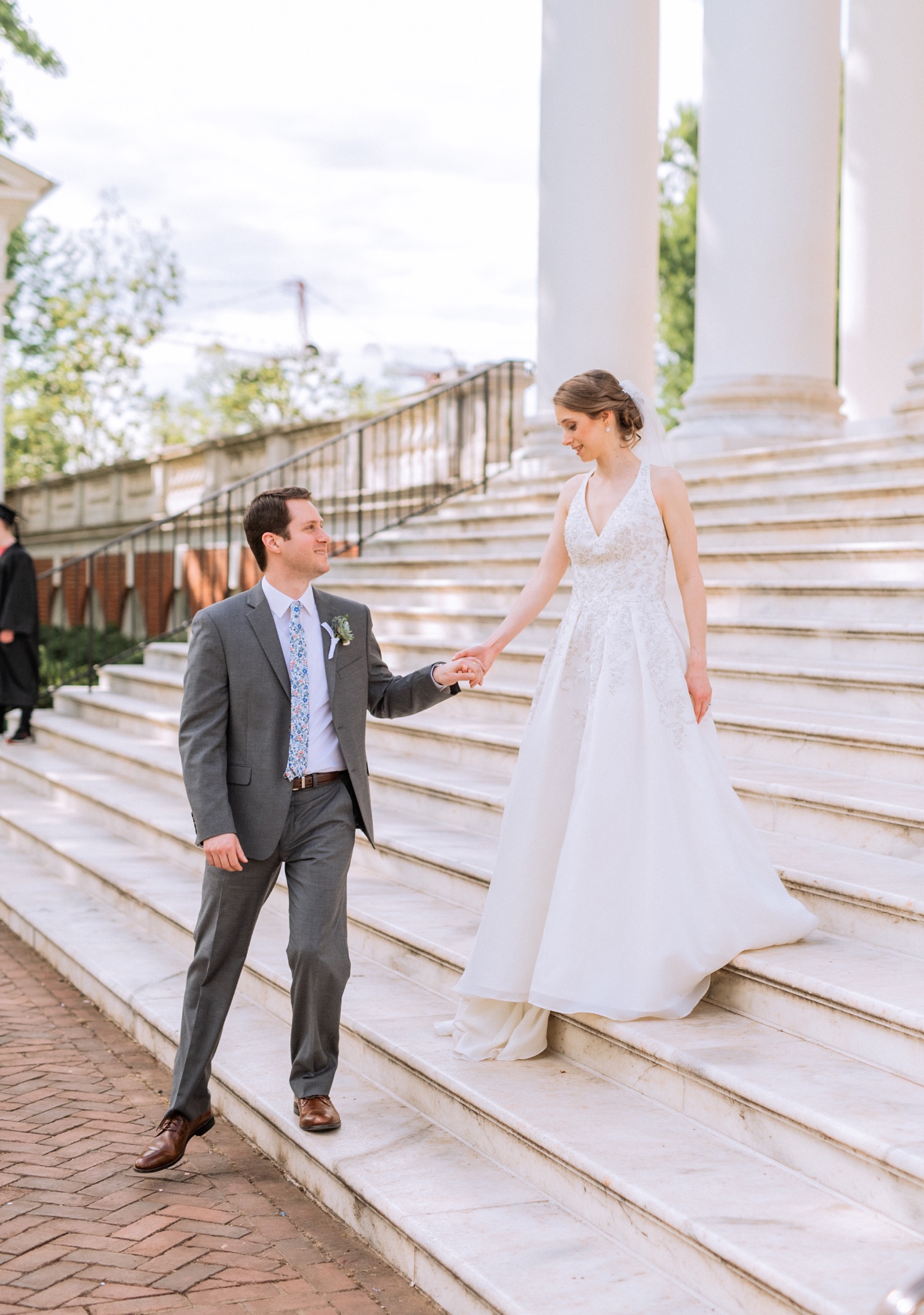 bride and groom walking down steps