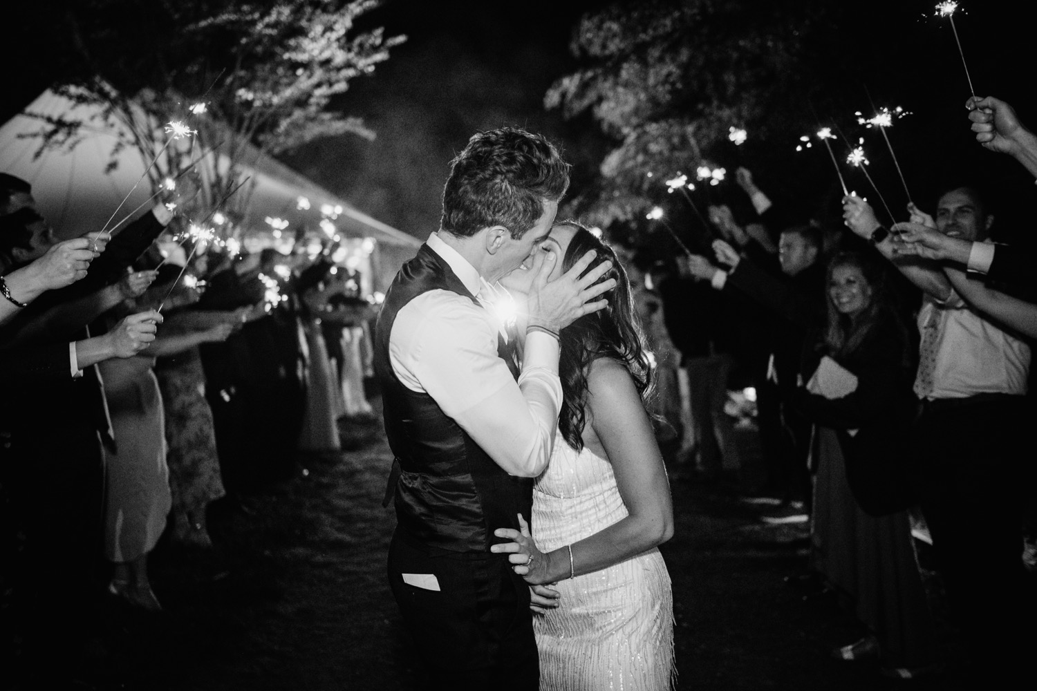 bride and groom kiss during end of reception at Keswick Vineyard wedding