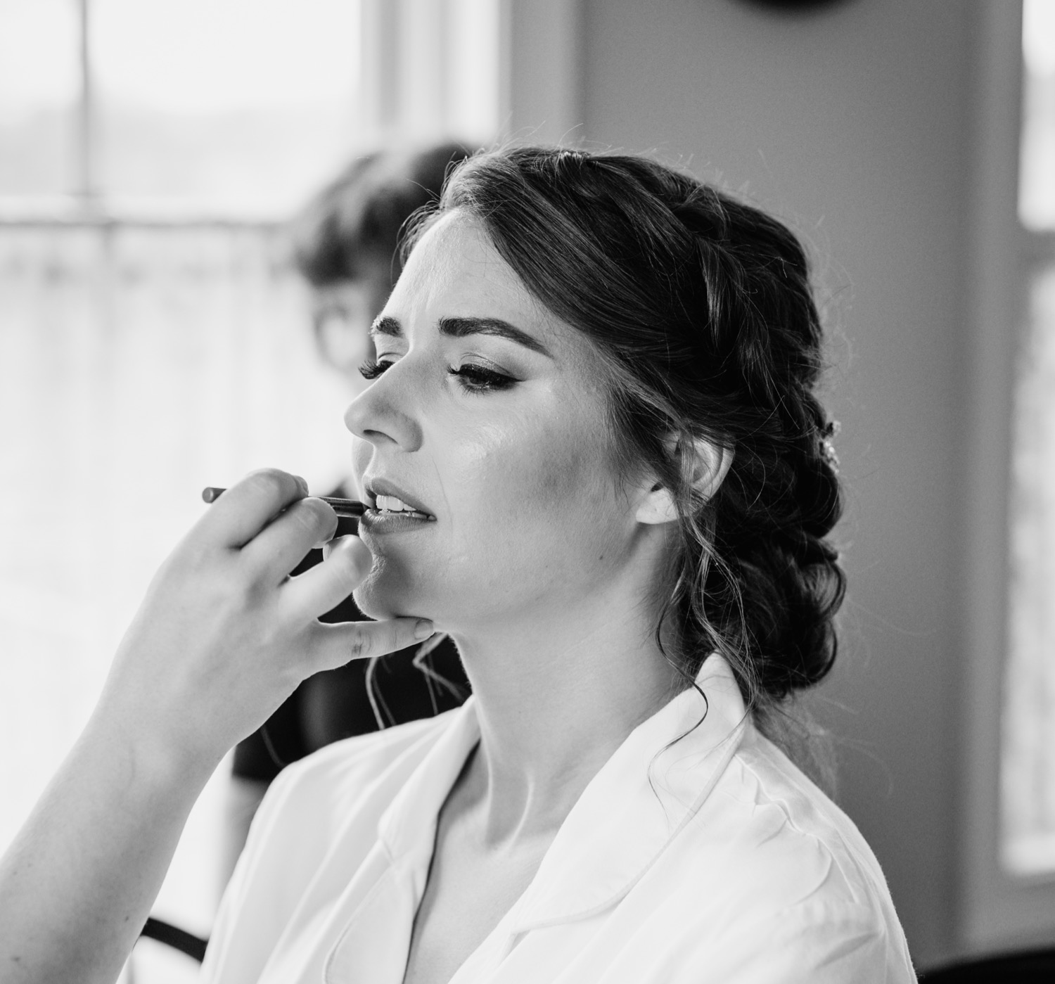 Bride finishing the makeup process before her wedding
