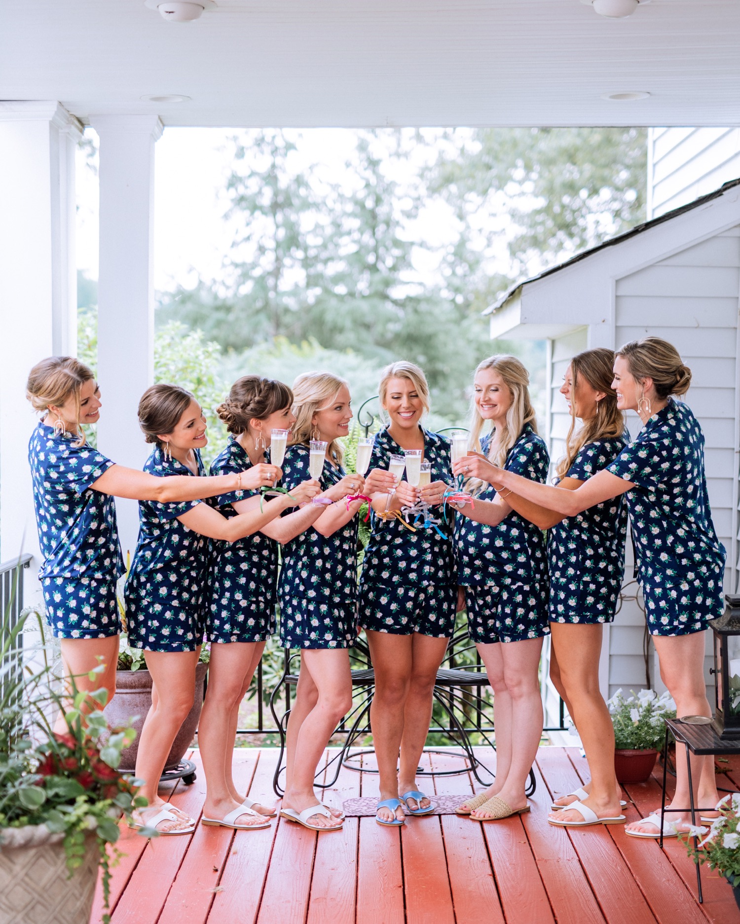 Bride and bridesmaids in matching polka dot pajamas sharing a champagne toast before wedding ceremony in Richmond, Virginia