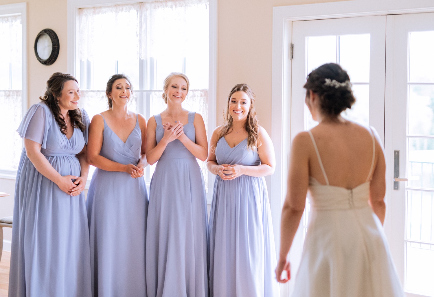Bride's first look with her bridesmaids before her wedding ceremony