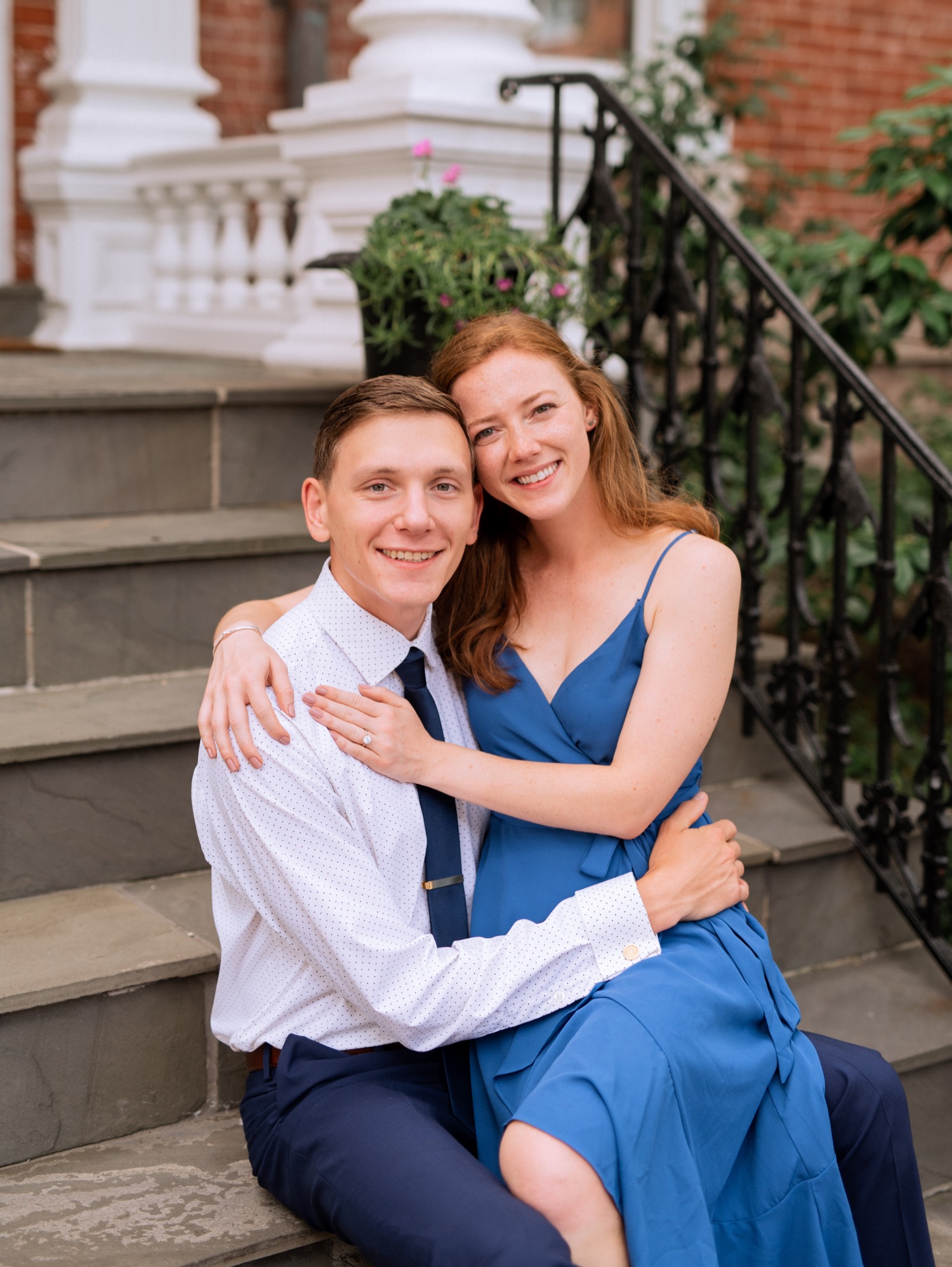 engaged couple hold each other close on staircase during engagement shoot in the freeman historic district in norfolk virginia