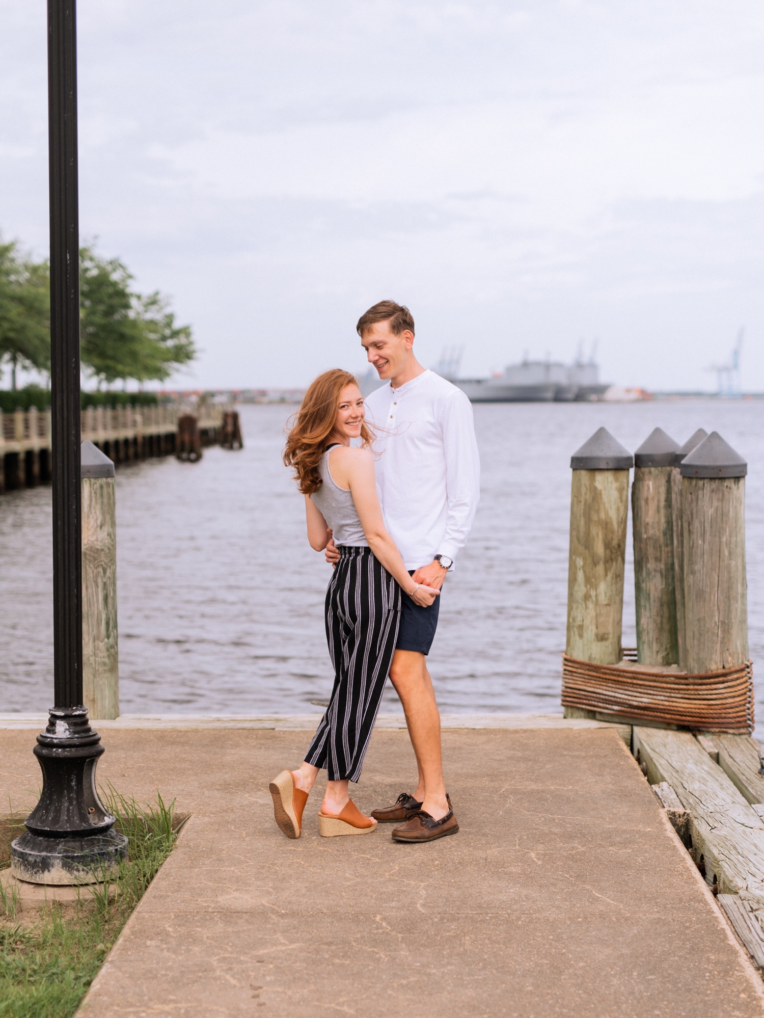 engaged couple hold each other close during engagement shoot in the freeman historic district in norfolk virginia