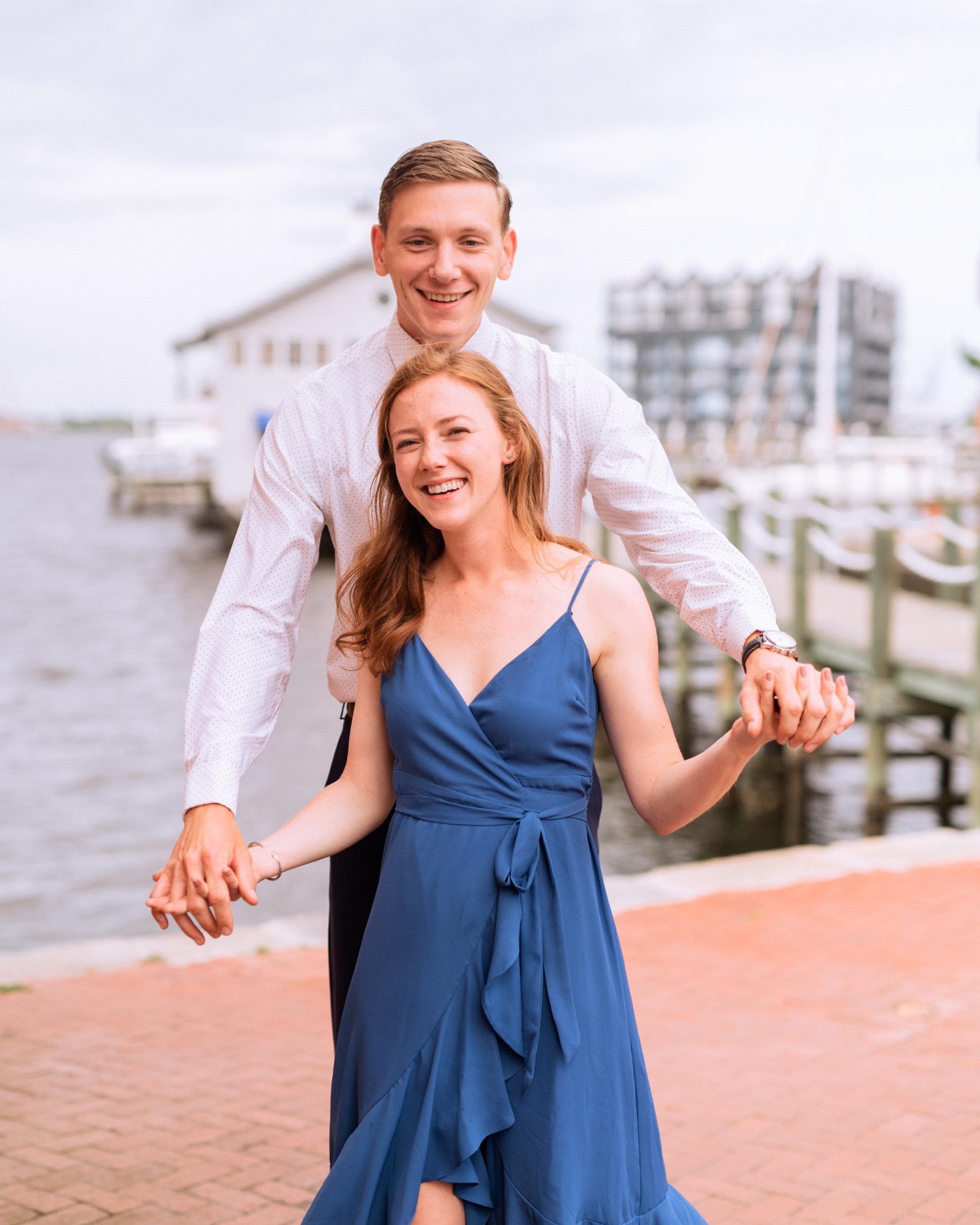engaged couple hold each other close during engagement shoot in the freeman historic district in norfolk virginia