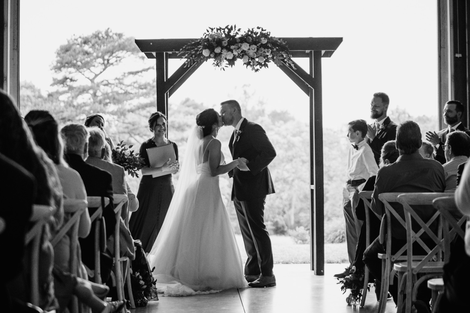 Bride and groom sharing first kiss at the alter in Charlottesville, VA wedding