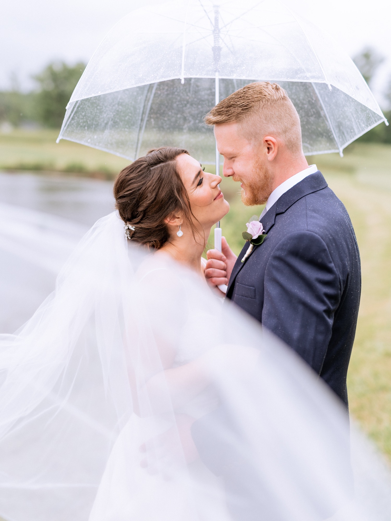 Bride and groom kissing in the rain after wedding ceremony in Charlottesville, VA