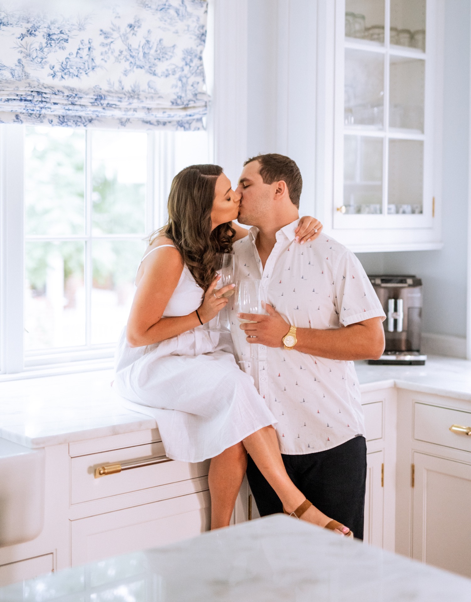 engaged couple kisses in kitchen at the cumberland estate in richmond virginia