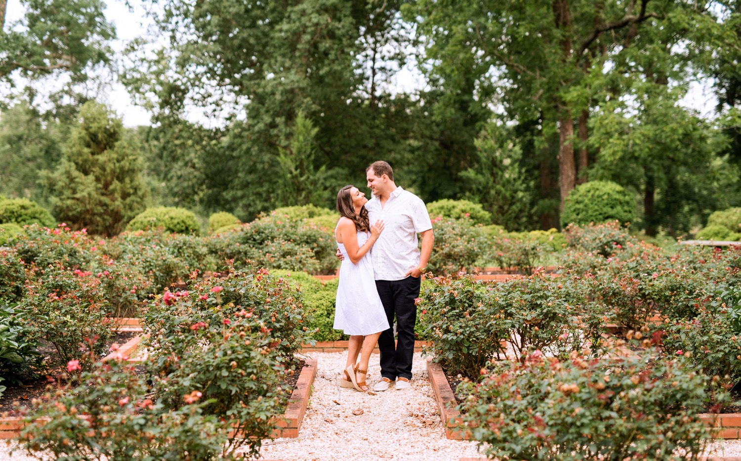 engaged couple looks into each others eyes in a secluded garden at the cumberland estate in richmond virginia