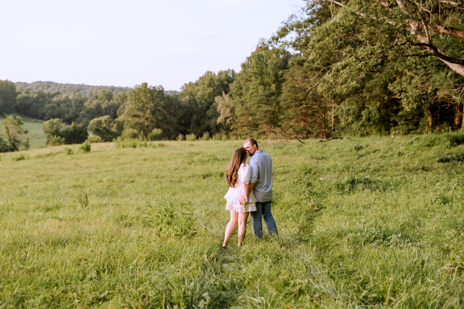 engaged couple kissing in their backyard in Madison Virginia