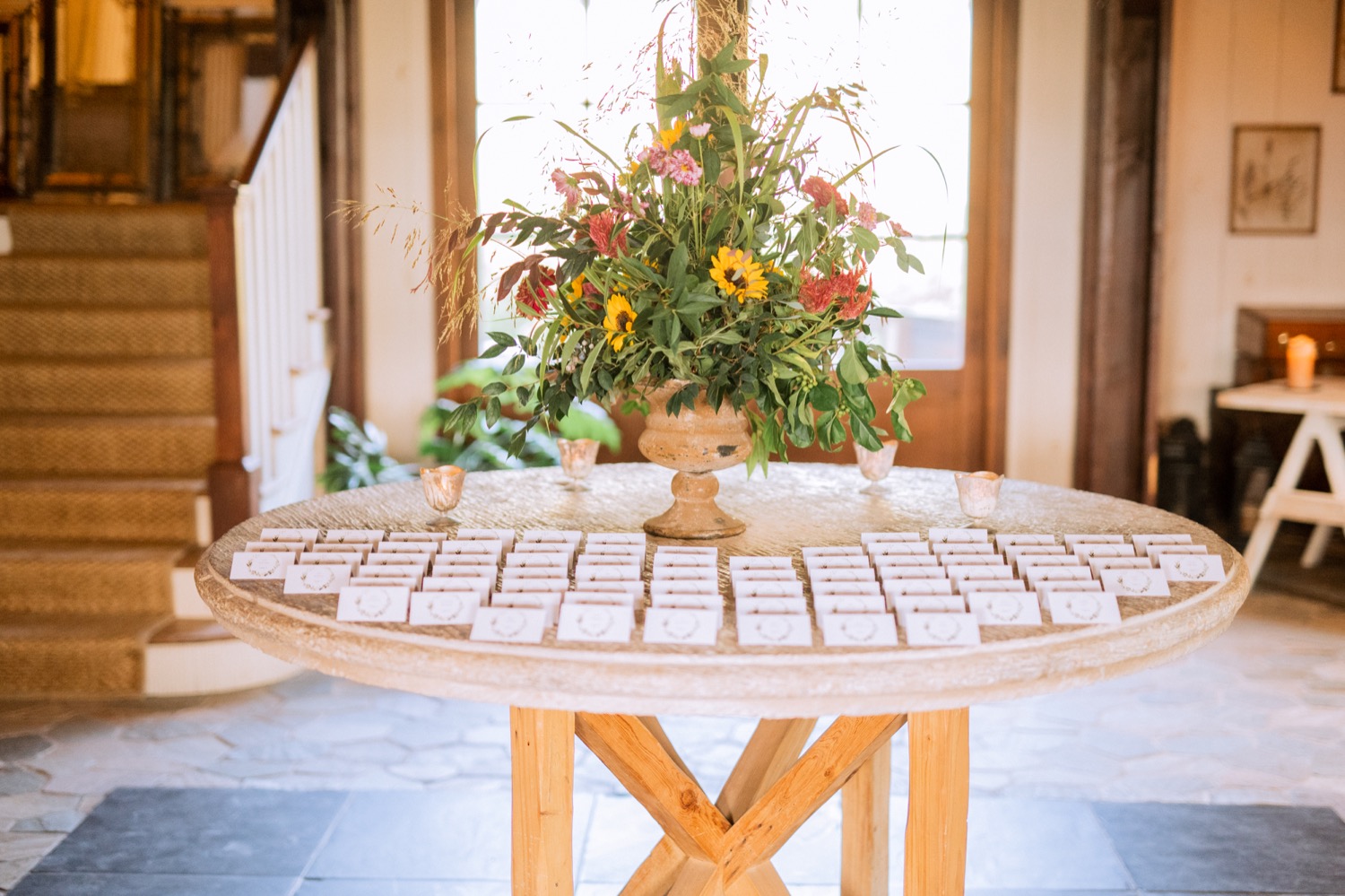 table with flower arrangement and seating cards