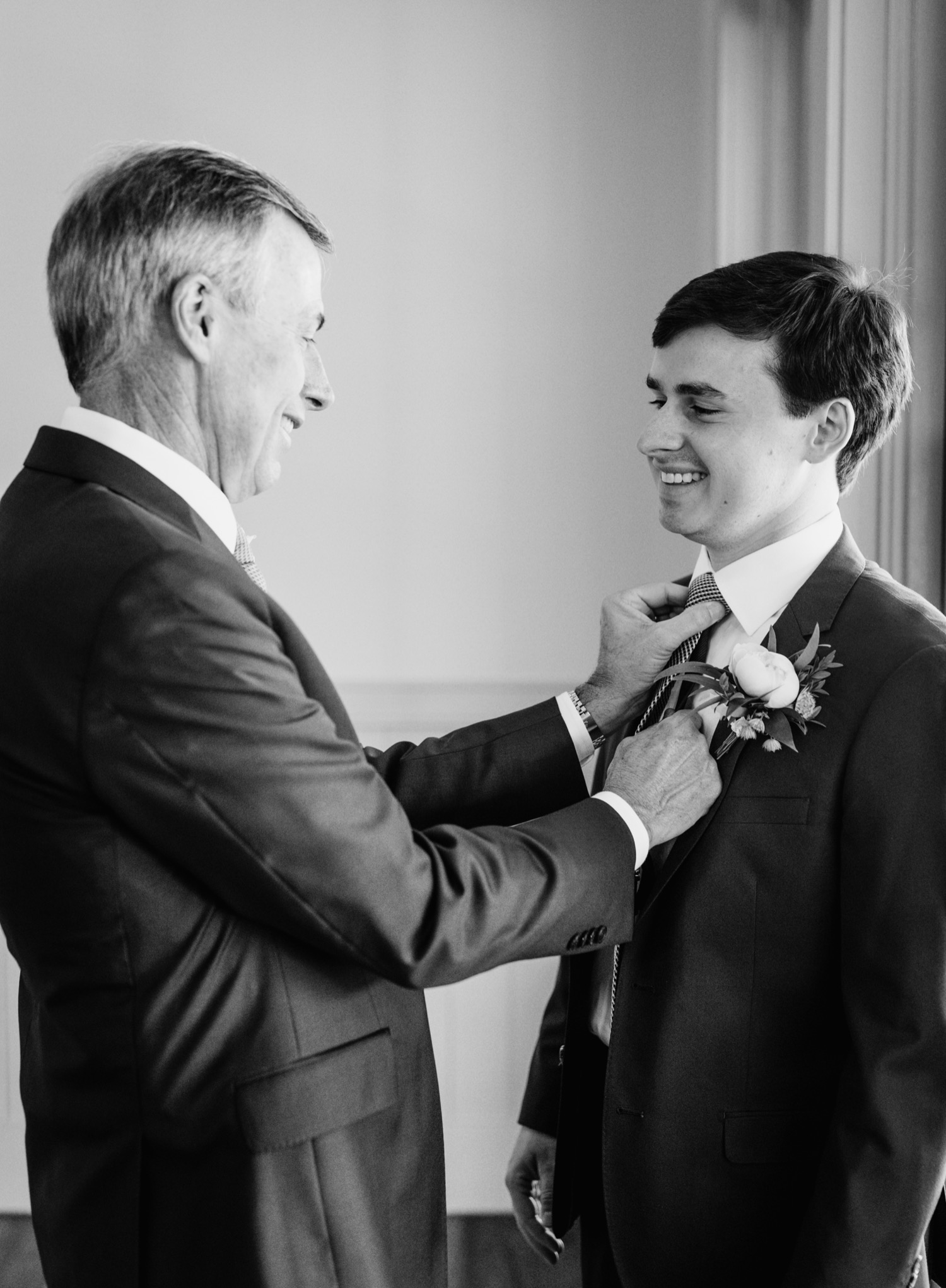 Groom and father putting on the finishing touches before the charlottesville wedding ceremony