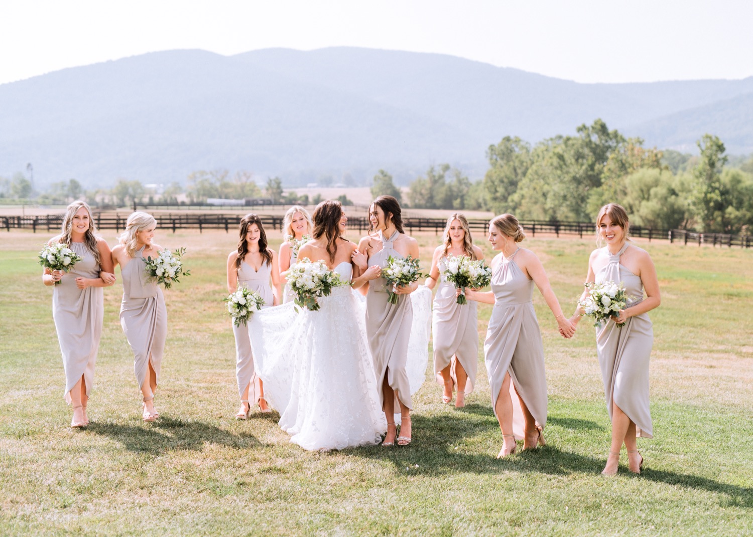 bride and bridesmaids in their taupe colored bridesmaids dresses celebrating the Charlottesville wedding day