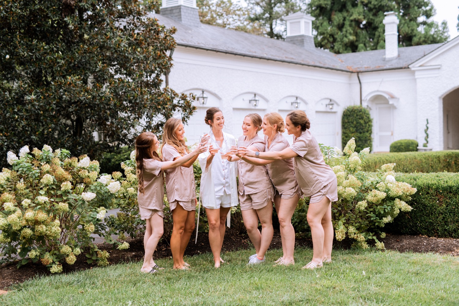 bride and wedding party in matching pajama sets as they prepare for the wedding in charlottesville, va