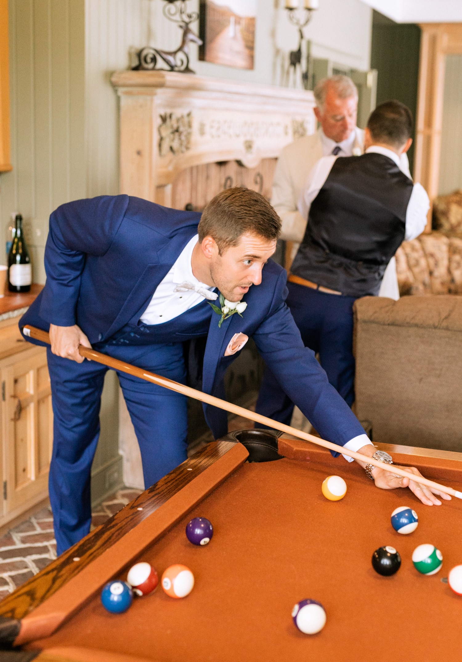 groom playing pool before his wedding ceremony at keswick vineyards in charlottesville virginia 
