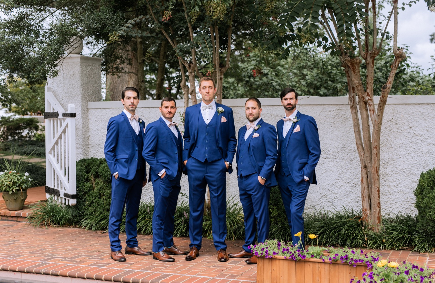 groom and groomsmen in navy blue tuxes as they prepare for the wedding ceremony at keswick vineyards in charlottesville virginia