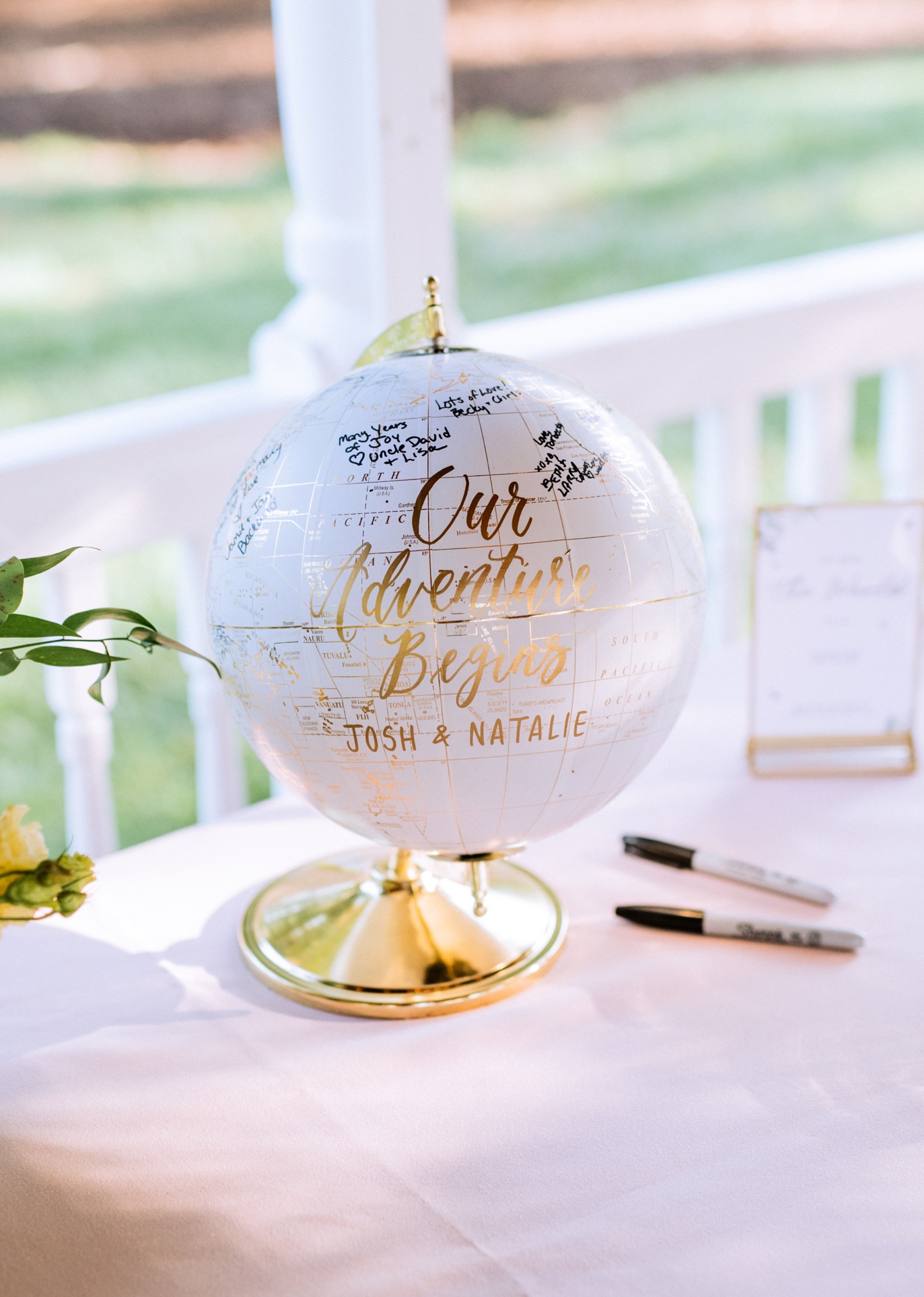 white globe with sharpies for bride and grooms friends and family to sign at their wedding reception