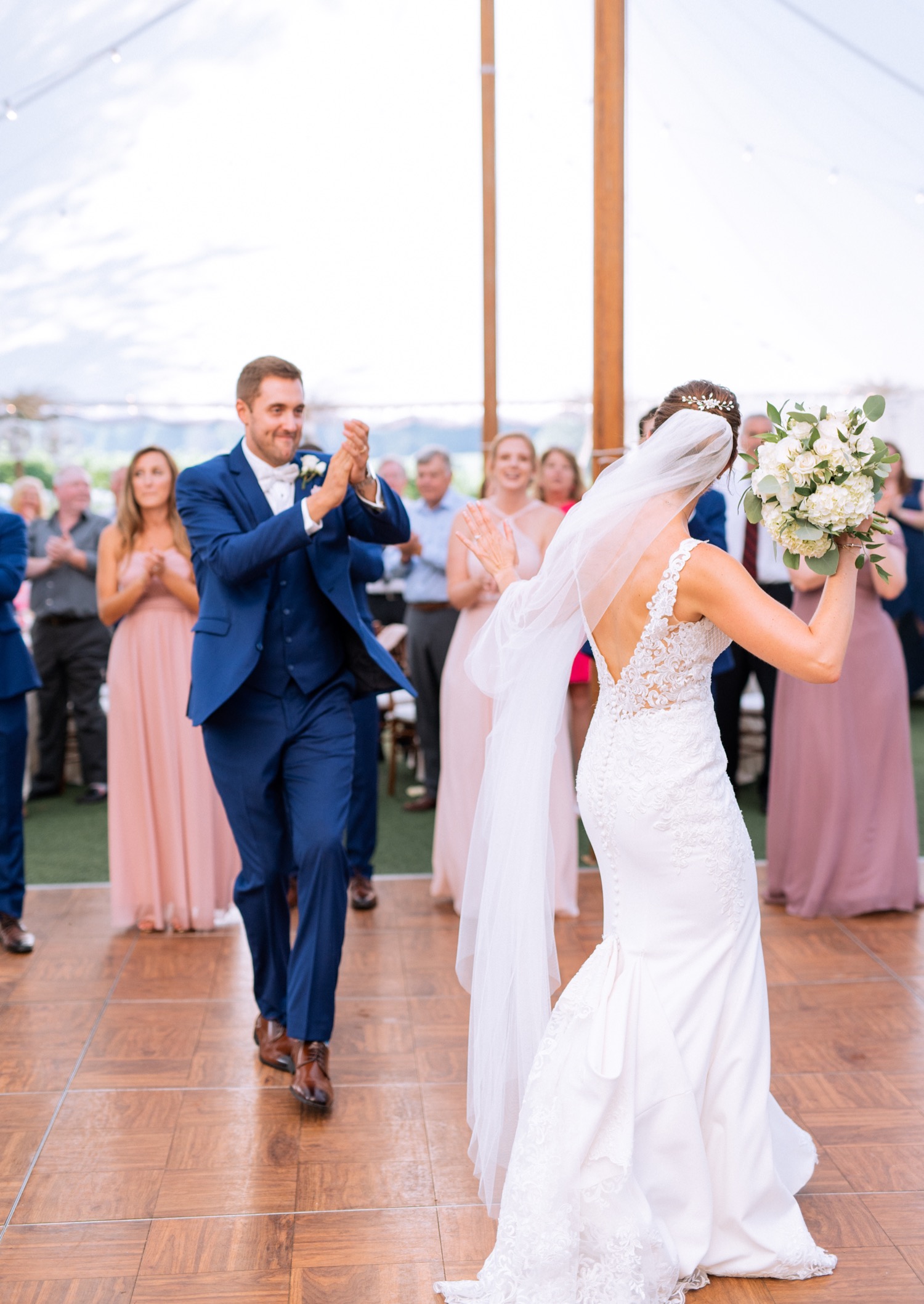 bride and groom celebrate while dancing together during their wedding reception