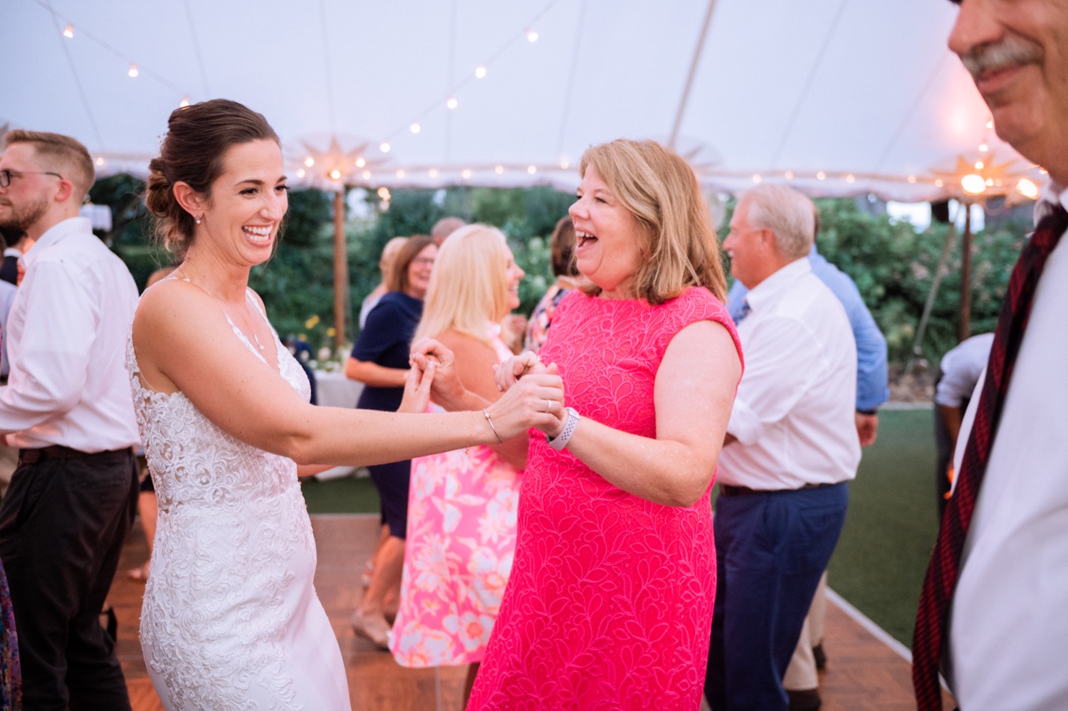 bride dancing with a guest at her wedding reception