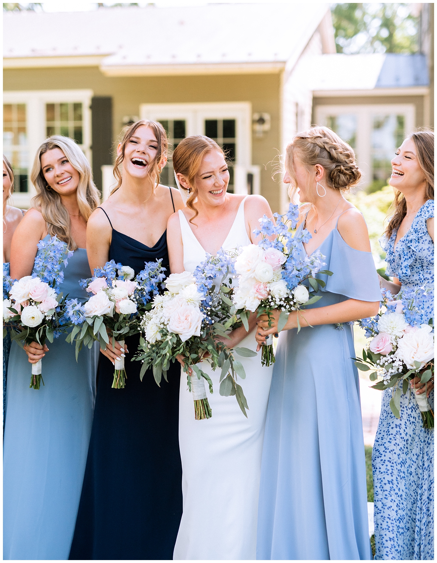 Bride with bridesmaids in mixed blue dresses at Fleetwood Farm Winery wedding in Leesburg, Virginia