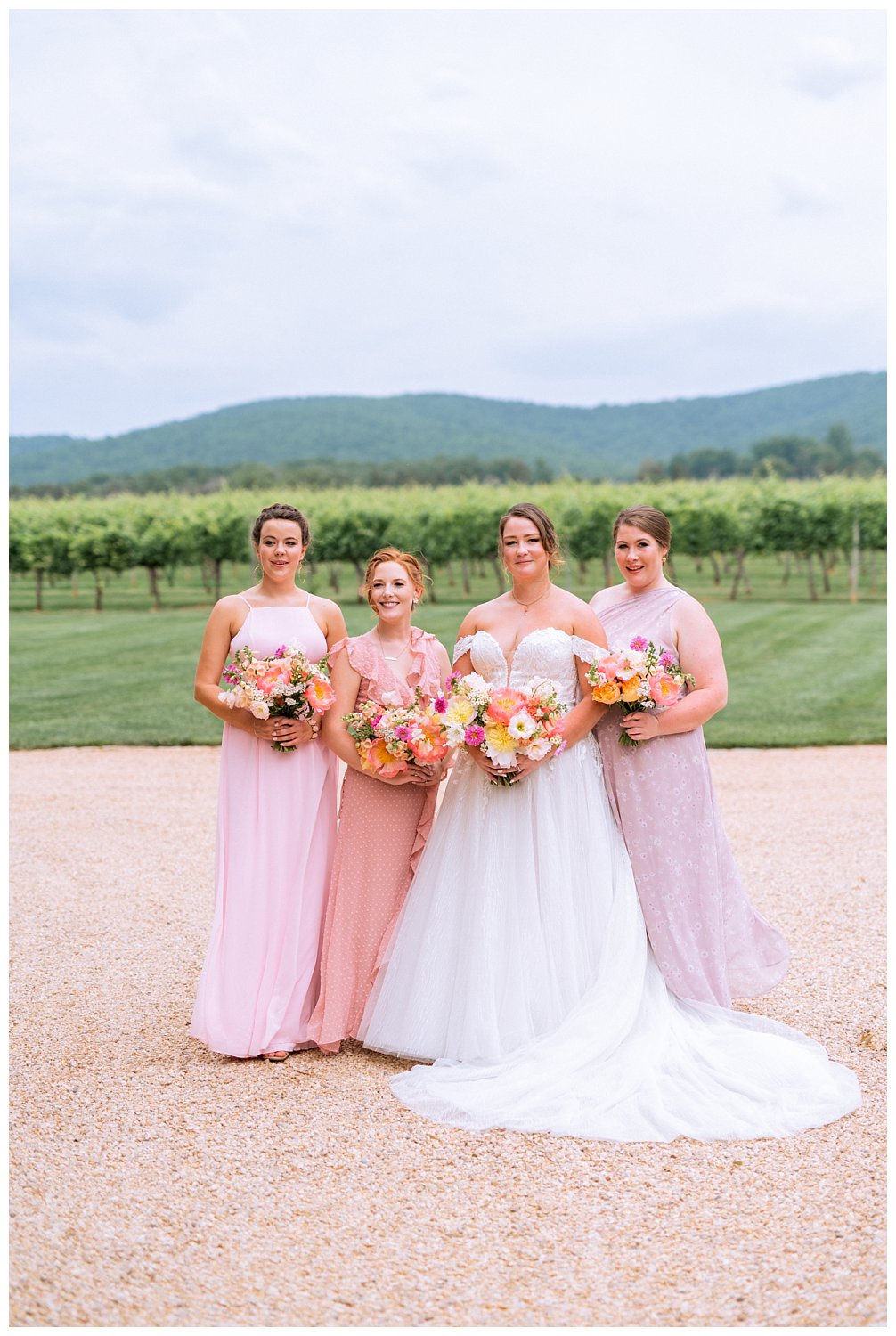 Portraits of bride with bridesmaids at a colorful summer wedding