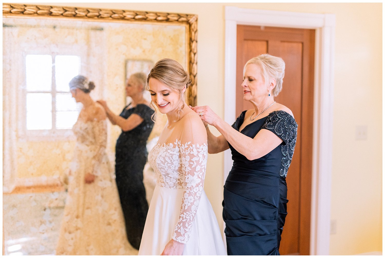 Bride putting on her dress at Early Mountain Vineyard in Charlottesville, Virginia