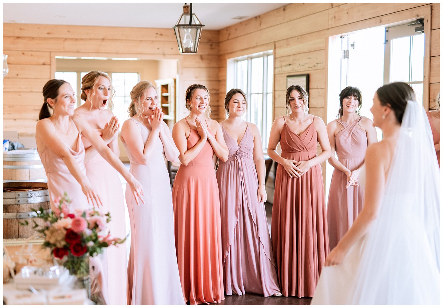 Bride reveal with bridesmaids in mismatching pink dresses