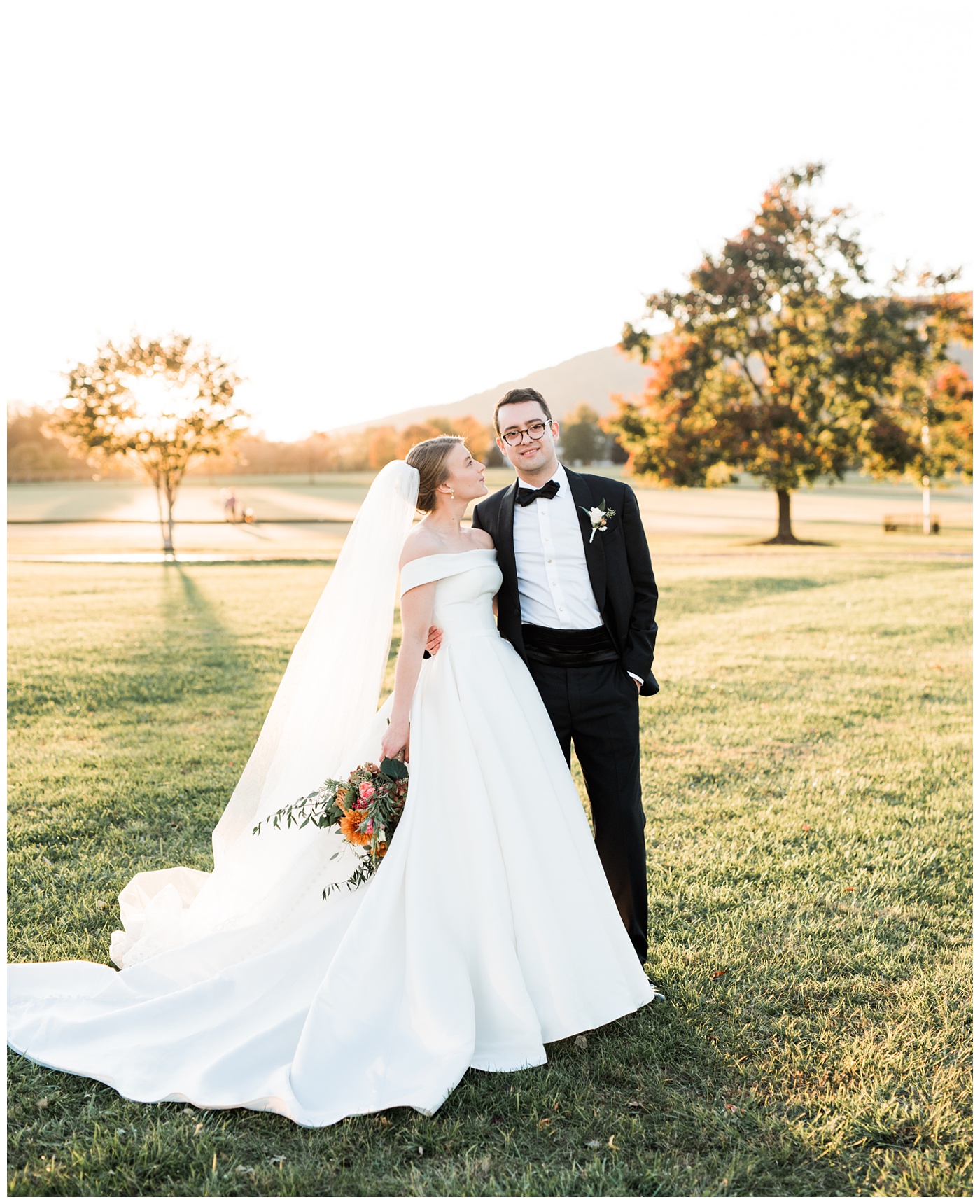 Bride and Groom with colorful Fall leaves and Virginia mountain backdrop at King Family Vineyard