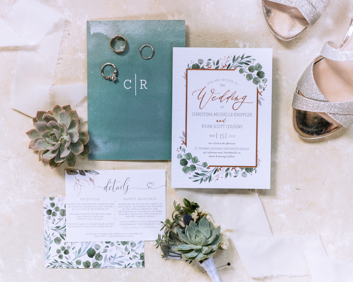 Wedding rings, invitation, and program pictured with succulents
