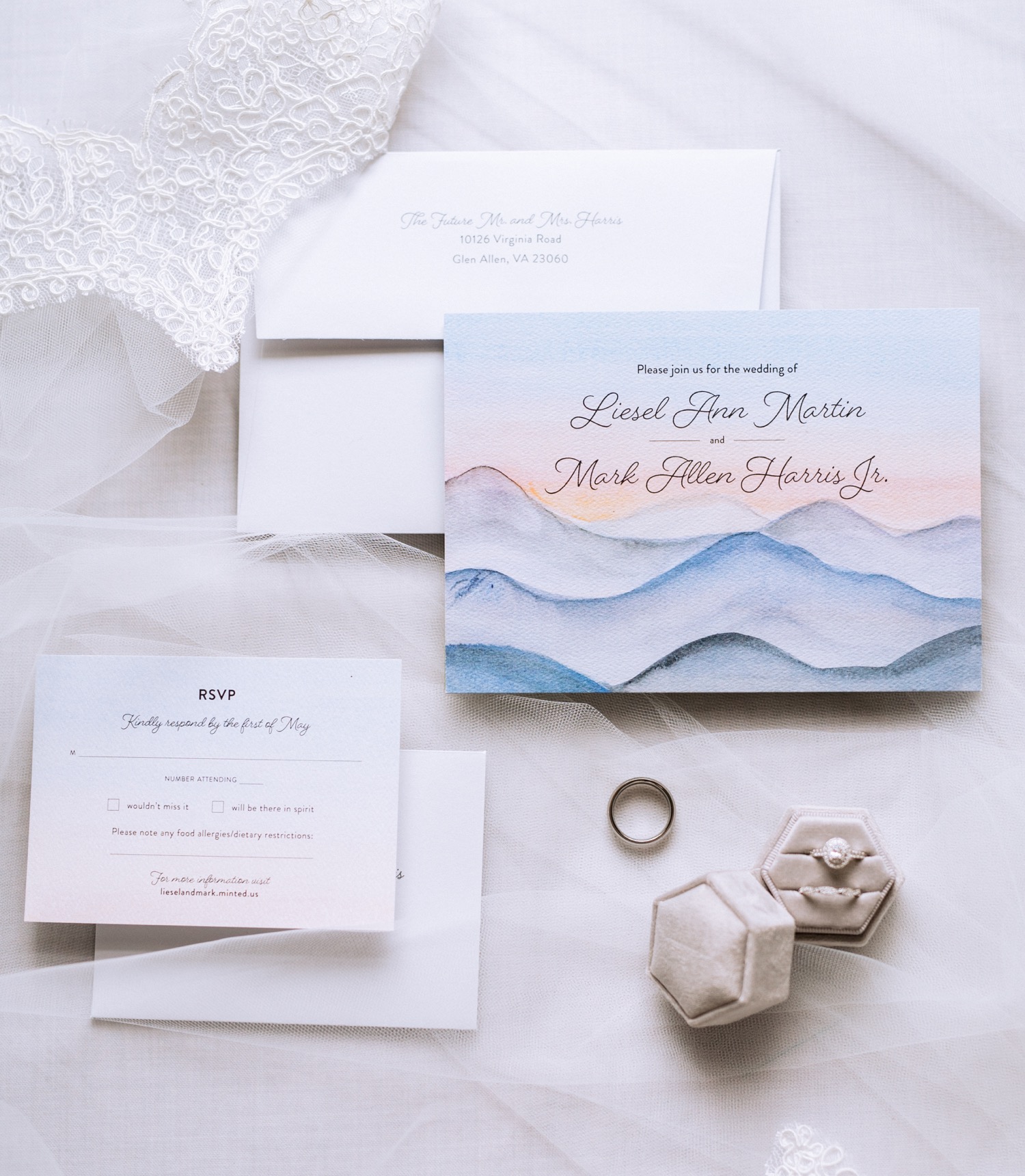 Wedding rings, invitation, and program are laid out before Charlottesville, VA wedding.