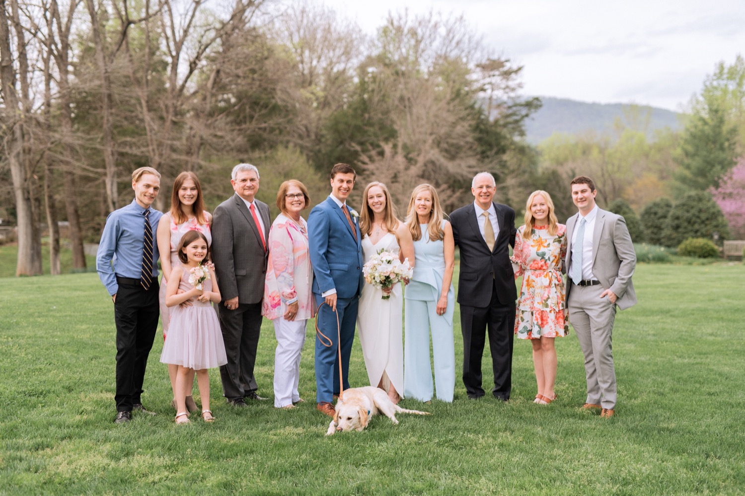 Wedding party posing with the family dog on the wedding day
