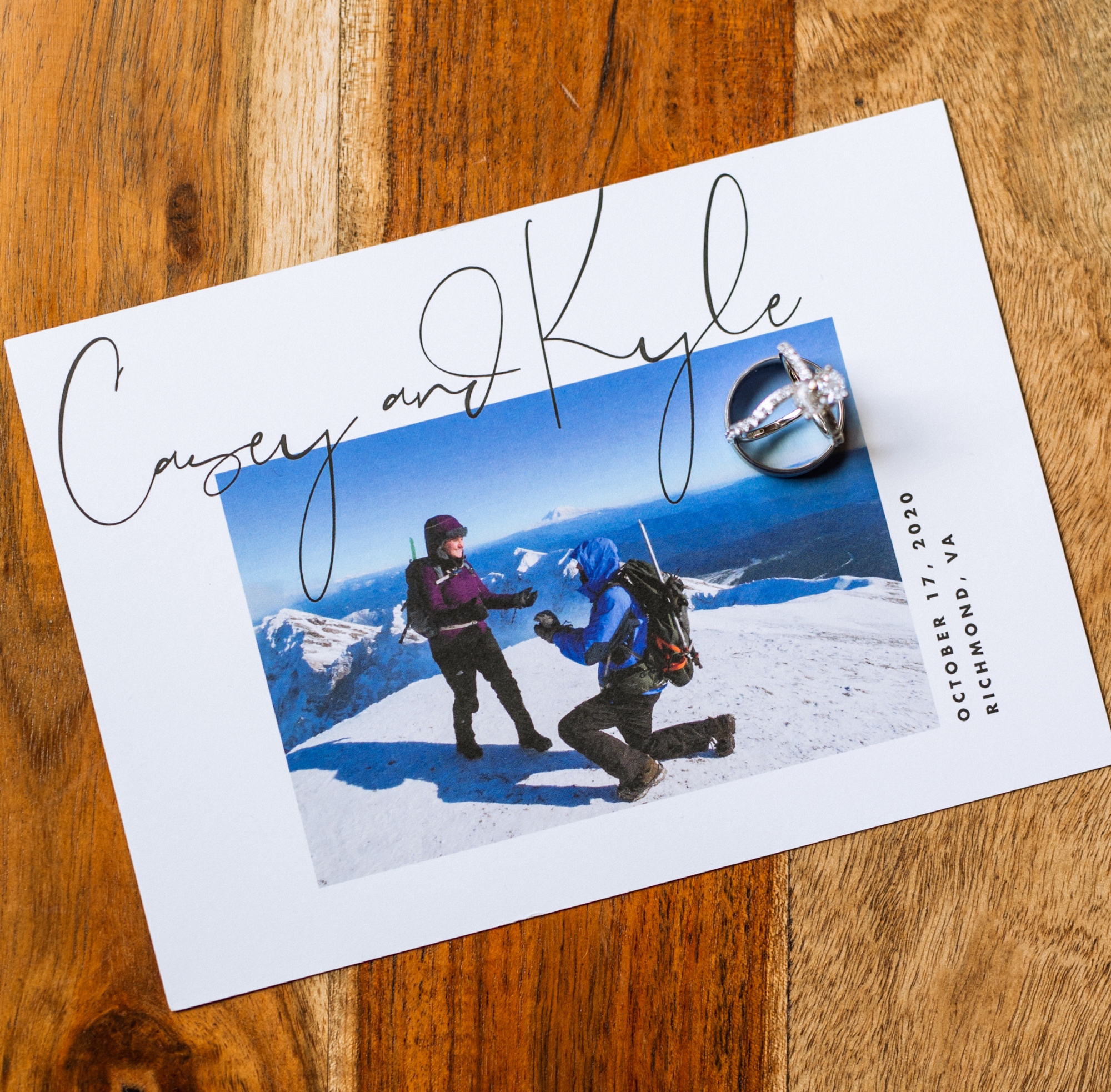 wedding invitation with a picture of the bride and groom on top of mountain, for elopement in mt rainier